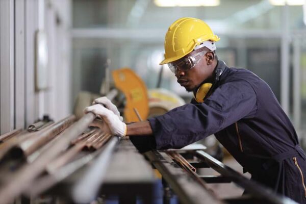 African American mechanic engineer worker is choosing copper tub